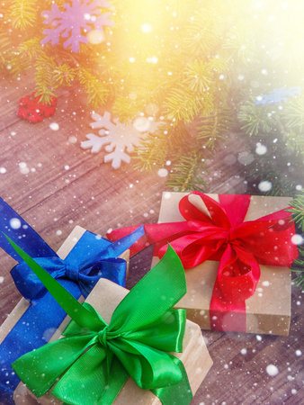 Christmas gift box with red ribbon on wooden background, many Christmas presents with decorations.