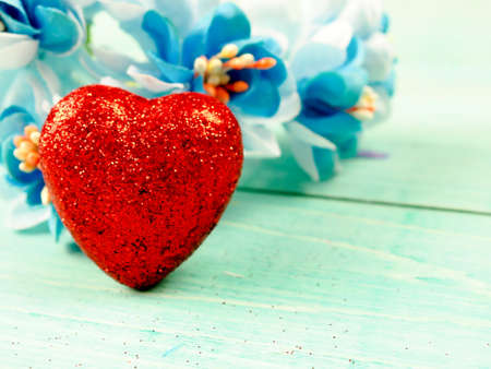 little red shiny hearts on blue background.の写真素材