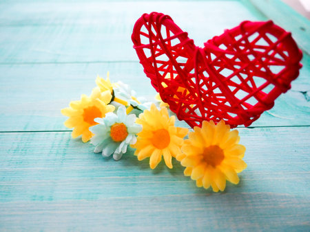 lots of little flowers and a red heart on the beautiful blue, turquoise background for the holiday...