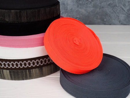 Ribbon of different colors in coils, many multi-colored coils for textile industry, clothing...