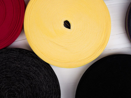 Ribbon of different colors in coils, many multi-colored coils for textile industry, clothing...