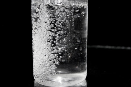 Splash of water on black, Stylish water splash. Isolated on black background, bubbles in the glass,...
