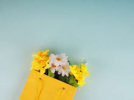 bottle of wine and flowers in the package on blue background, space for text.の写真素材
