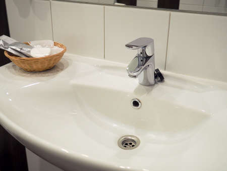 faucet flowing water in the bathroom, sink with tapの写真素材