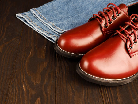 Fashionable concept. casual wear, yellow work boots from natural leather, blue jeans on black...