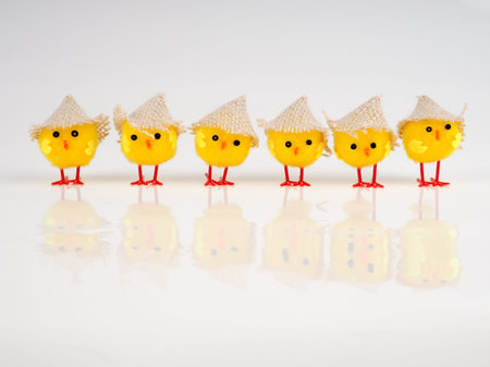 little baby toy chicken on a white background, a lot of chickens, the concept for Easter.
