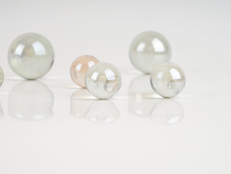 Glass marbles on a grey surface. beautiful reflection, abstract background