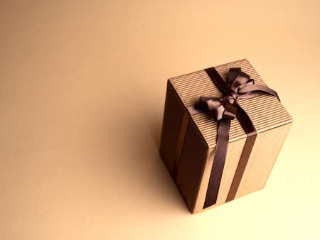 Group of gift boxes wrapped with kraft paper and brown satin ribbon . Modern presents for any holiday, christmas, valentine or birthday.の写真素材