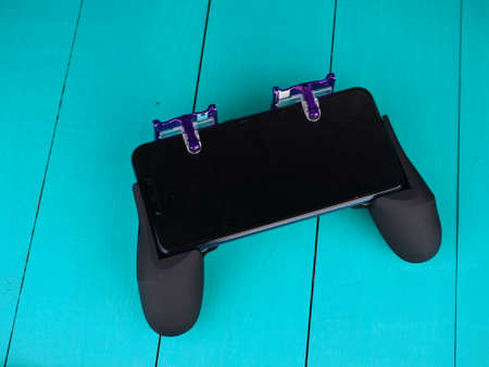 gamepad for smartphones on the blue backgroundsの写真素材