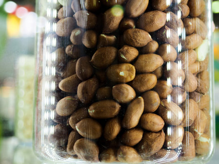 Nut mix in glass jars, hazelnuts, almonds, cashew on white background. Selective focus, copy space.