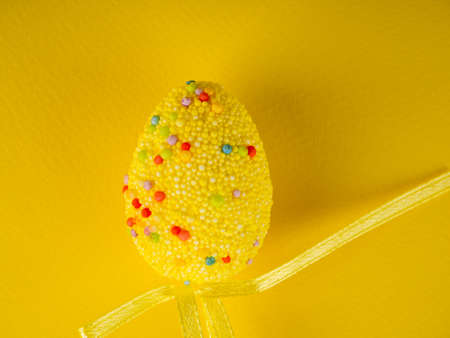 Easter holiday background. coloured decorated easter eggs on a bright yellow backgroundの写真素材
