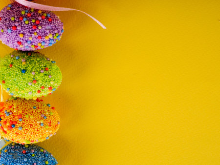 Easter holiday background. coloured decorated easter eggs on a bright yellow background