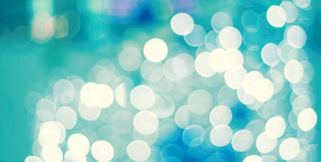 Colorful lights on red background. holiday bokeh. Abstract Christmas background, blur blue and white bokeh lightの写真素材