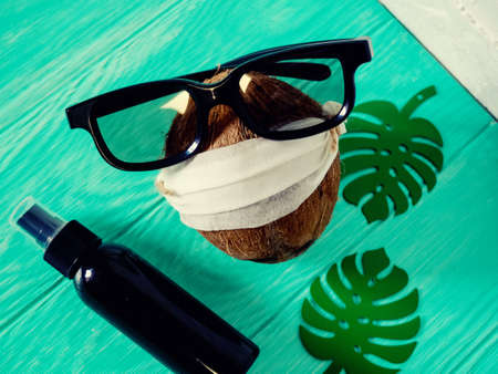 coconut in a homemade mask to sit at home in the country close. Near antiseptic. Coronavirus outbreak or Covid-19, Concept of Covid-19 quarantine. Dangerous COVID virus, Doomsday panic people panic.の写真素材
