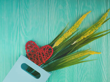 braided pink heart on a wooden background. concept of love, Valentine's day, wedding, place for text.の写真素材