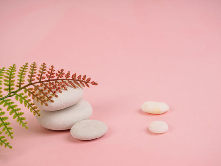 Stack of Zen stones on abstract pink background. Relax still Life with folded stones. Zen pebbles,...