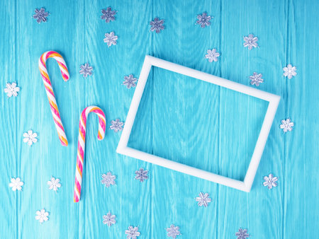 Christmas candy cane. two Christmas candy cane with frame on blue wooden background, space for text....