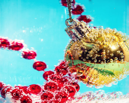 Christmas ball in water with bubbles, Christmas card concept.