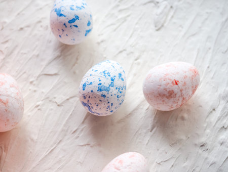White foam eggs on blue background. Flat lay, top view. Easter concept.