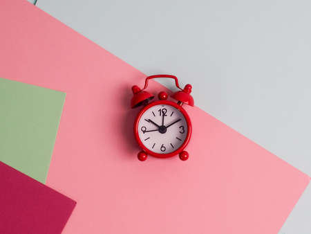 Metal retro vintage alarm clock wakeup clips clipboard, paper sheet pencil notepad lying colored background empty text important events what to do office school homeの写真素材