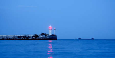 banner lighthouse at sunset in the twilight in clear weather in Crimeaの写真素材