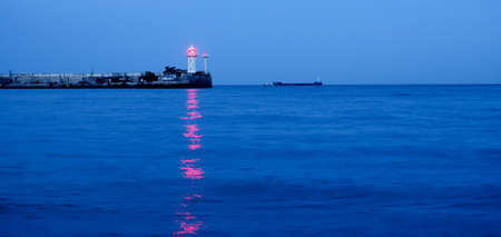 banner lighthouse at sunset in the twilight in clear weather in Crimeaの写真素材