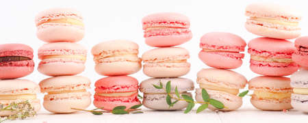 banner Colorful French or Italian macarons stack on white wood table with copy space for background. Dessert for served with afternoon tea or coffee break.の写真素材