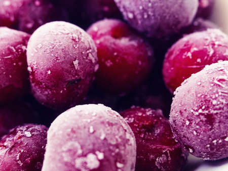 Red berries frozen cherry winter food background.の写真素材