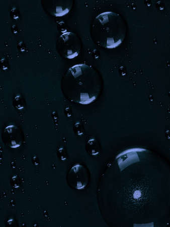 drops of blue dark background as a backing. Large drops close up abstract for backgroundの写真素材