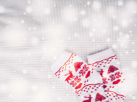 Christmas socks red lie on a white bed waiting for the new year, space for design, selective focus-の写真素材