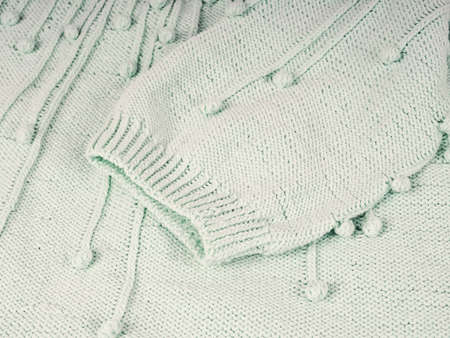 Abstract knitted background. Wool sweater with sleeves. Close up picture of knitted patternの写真素材