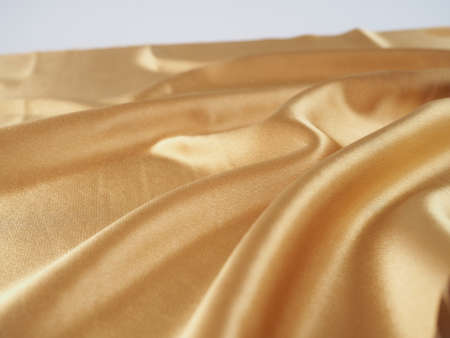Smooth elegant golden silk can use as wedding background. In Sepia toned. Retro style. silk fabric artistic layout. Texture, background. templateの写真素材
