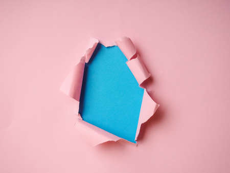Ripped Paper Hole with pink and blue colored background.の写真素材