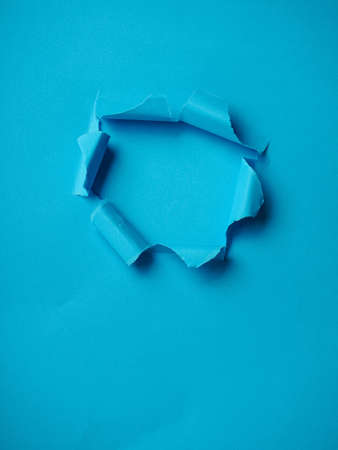 Ripped Paper Hole with blue colored background.の写真素材
