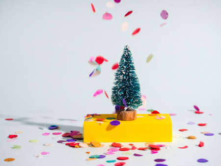 minimalism Christmas, one Christmas tree on a colored background with multi-colored abstract figures, the concept of Christmas and new year.の写真素材
