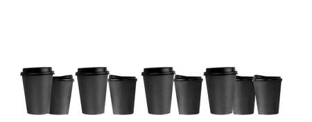 several black paper coffee cups in a row, a banner of disposable cups.の写真素材