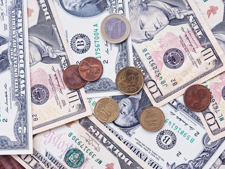 background of Euro and dollar banknotes and coins, the concept of Finance and poverty.の写真素材