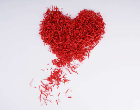 red heart from recycled materials, paper through shredder, the second life of things.の写真素材