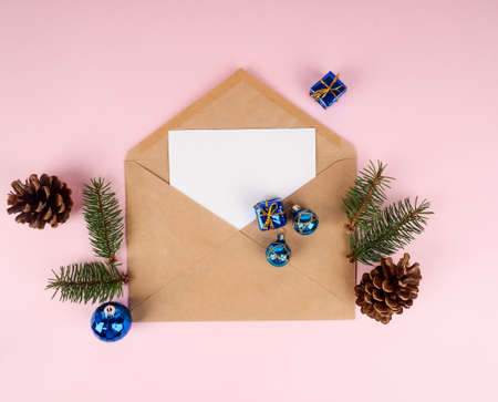 Christmas tree in envelope, minimal New Year s card. Spruce branch on pink background. Holidays, Congratulation concept, blue ball.の写真素材