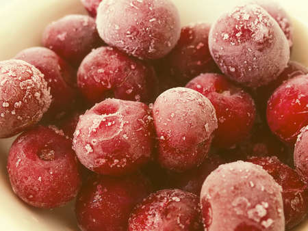Frozen sweet cherry. Red berries frozen cherry winter food background.の写真素材