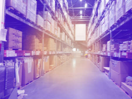 Blured Rows of shelves goods boxes in modern warehouse store at industry, storage prepared to be distributed to retailersの写真素材