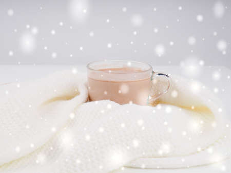 Gourmet Hot Chocolate Milk. cocoa mug with marshmallows on a white sweater on a brown wooden background.の写真素材