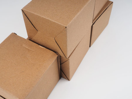 several cardboard boxes. Cardboard Boxes Stacked Against White Background.