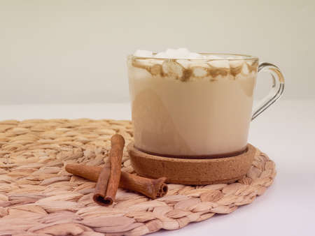 Gourmet Hot Chocolate Milk. cocoa mug with marshmallows on a white sweater on a brown wooden background.の写真素材
