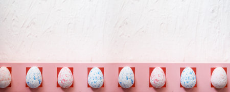 banner easter, holidays and tradition concept - row of colored artificial eggs on pink.