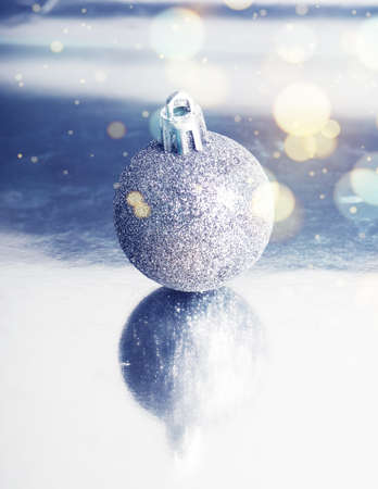 silver ball on background with reflection, minimalism Christmas.の写真素材