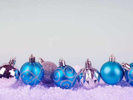Blue Christmas balls with decoration on blue background.の写真素材