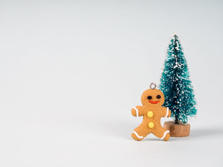 Gingerbread man and a small Christmas tree. traditional Christmas dessert cookies.