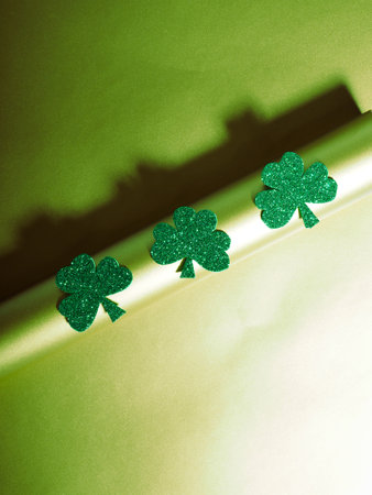 Green hat with golden coins and shamrock on gold table, st patricks day conceptの写真素材