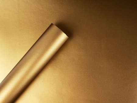 Gold paper rolled up in a tube, in a circle, abstract background for the designの写真素材